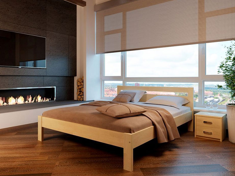 Дерев’яне ліжко з натуральної деревини в інтер’єрі спальні